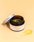 Photo of Mummy's Organics Organic Scar Balm from the top with the lid next to it