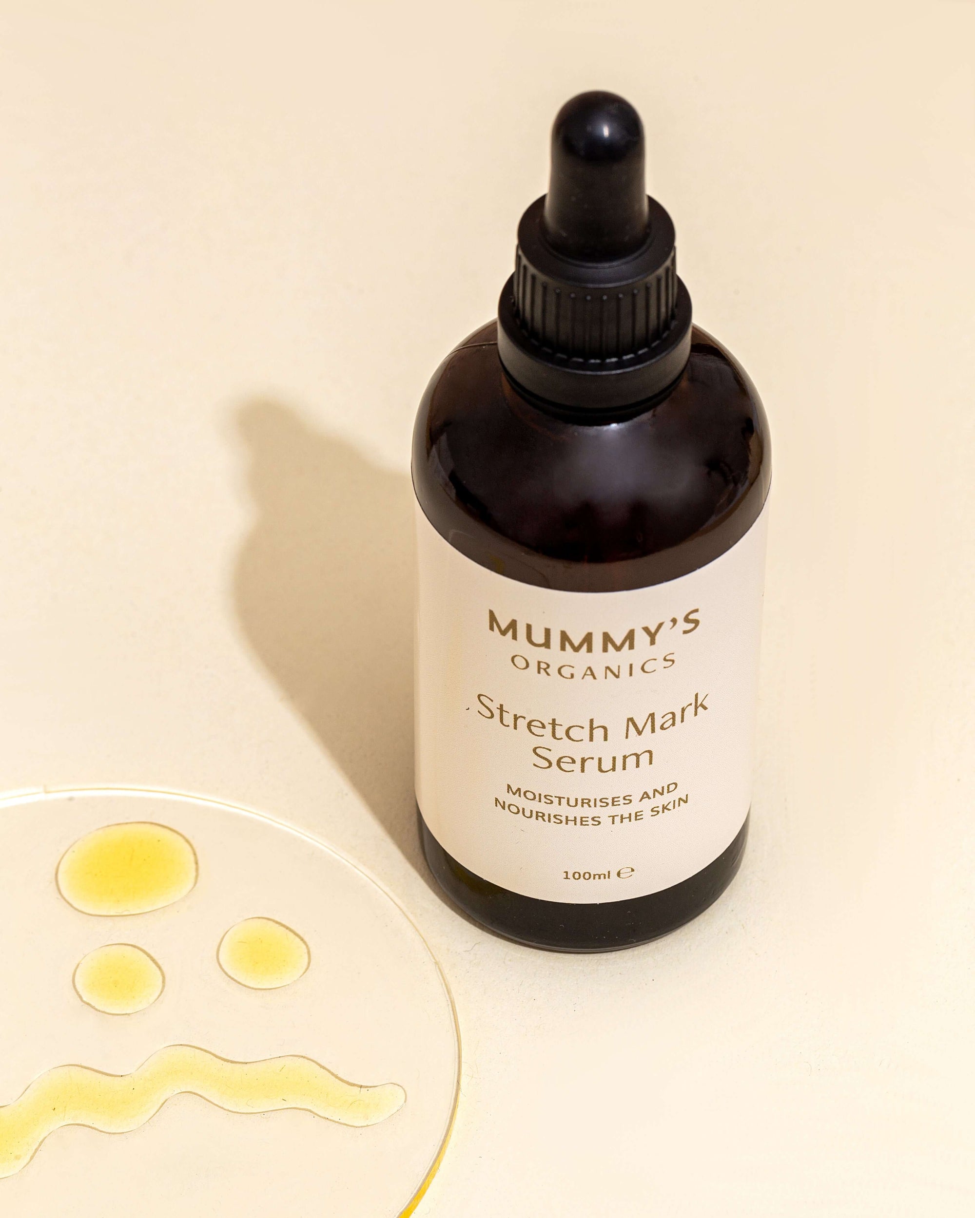 Photo of Mummy's Organics Organic Stretch Mark Serum Box with some oil on a dish next to it